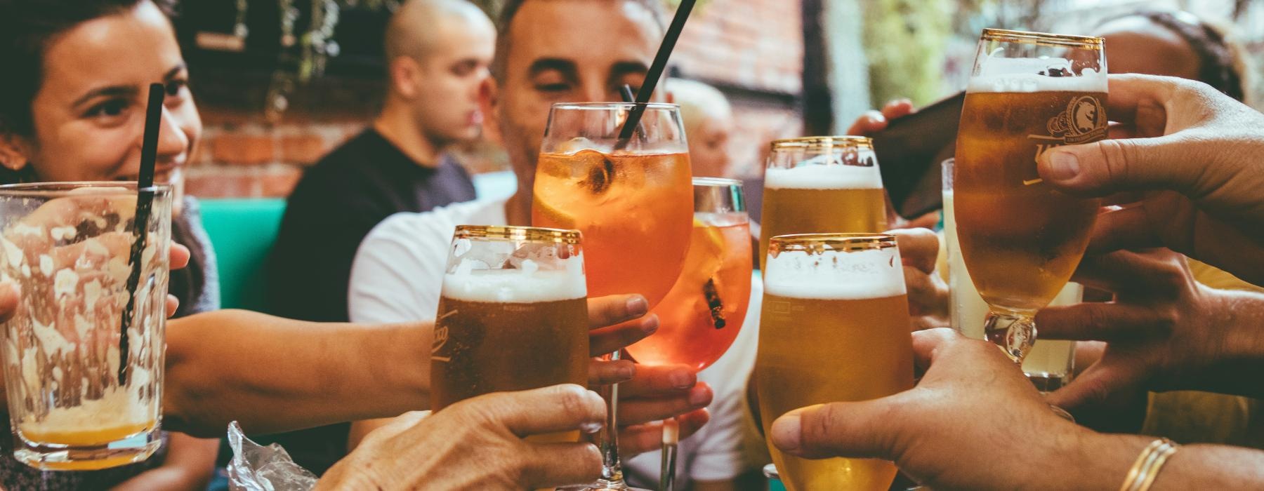a group of people holding glasses of beer